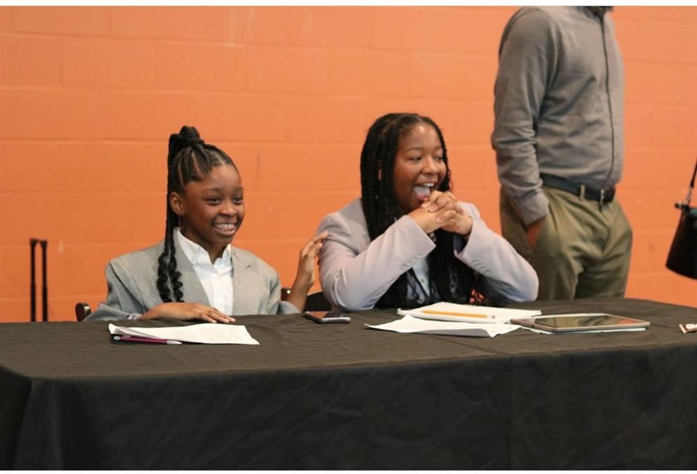  two girls sitting at a table